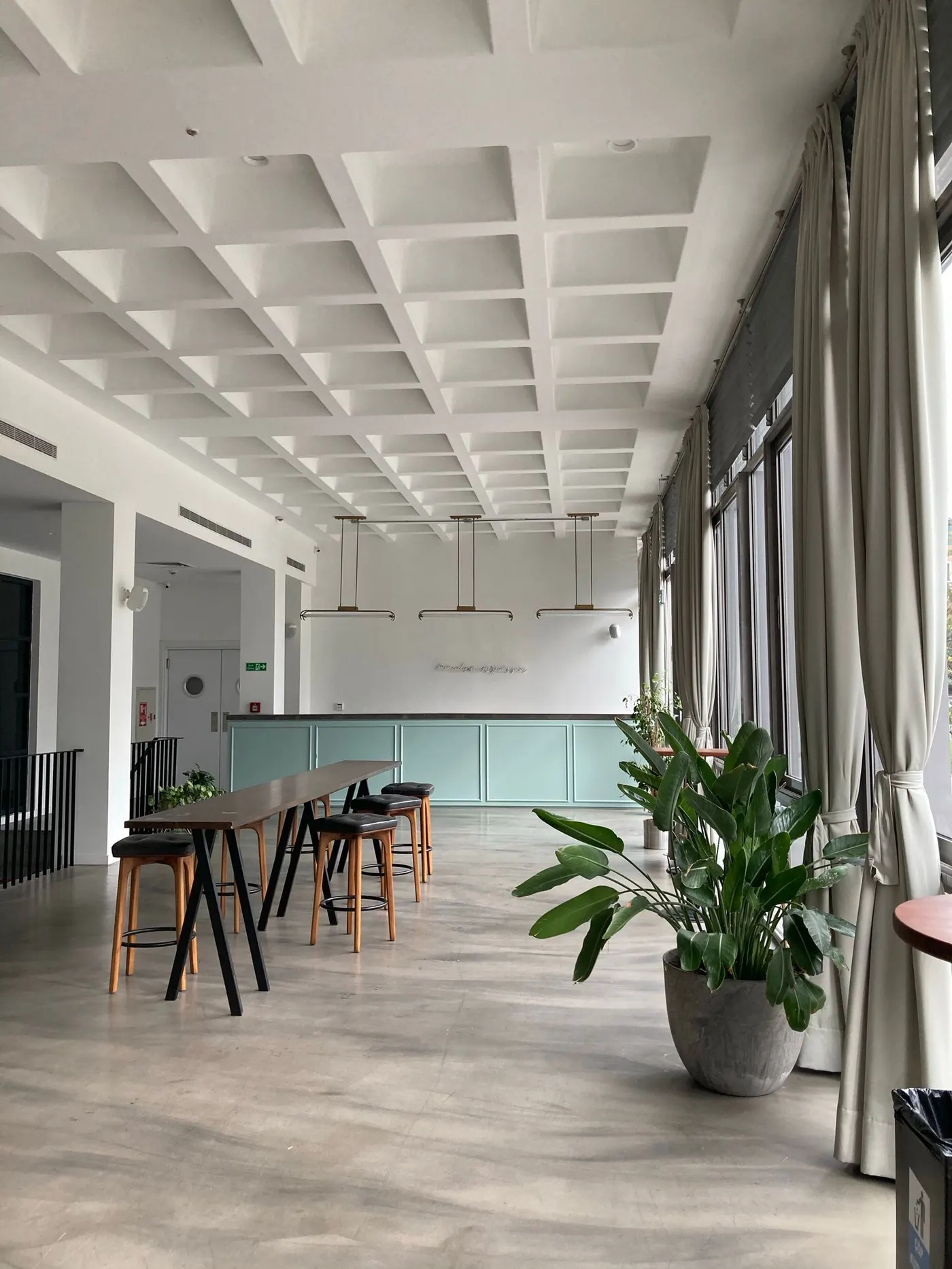 Commercial interior build-out with exposed ceiling grid and framing